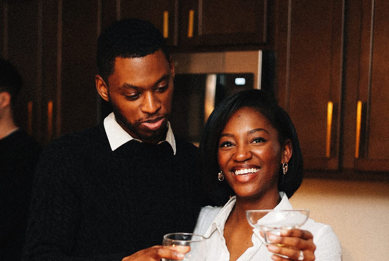 A couple sharing a toast at a candlelit dinner